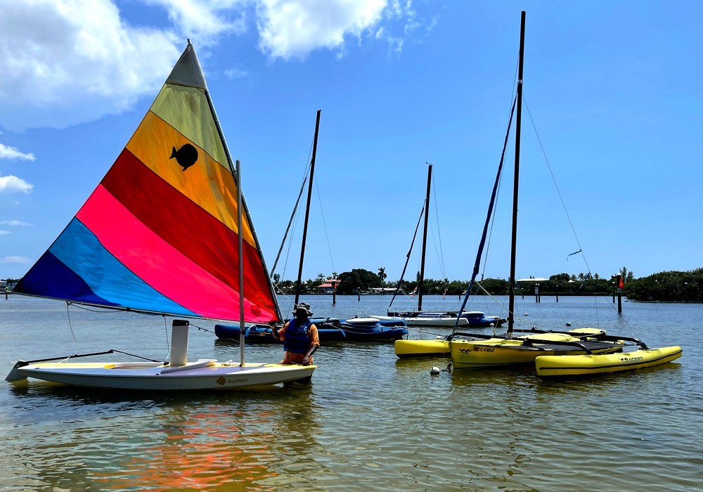 A Sunfish and a WindRider sailboat